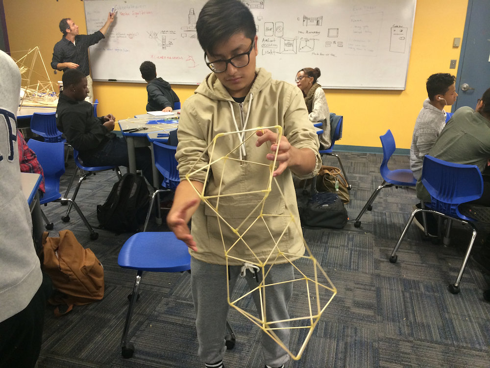 Student exploring tensegrity and a tesseract (time portal) in math class at Boston Arts Academy. Photo courtesy of Nettrice Gaskins.