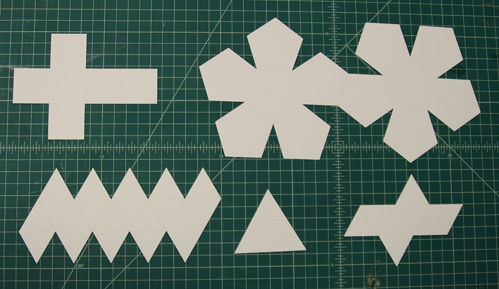 Laser cut platonic solids with scored grooves for easy folding, laid flat