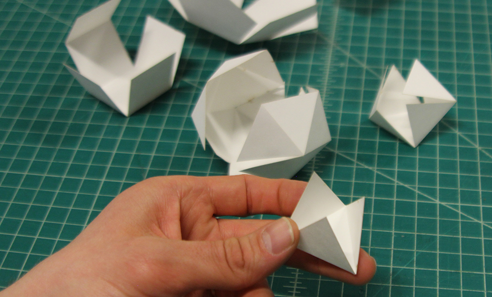 Laser cut platonic solids, folding in process.